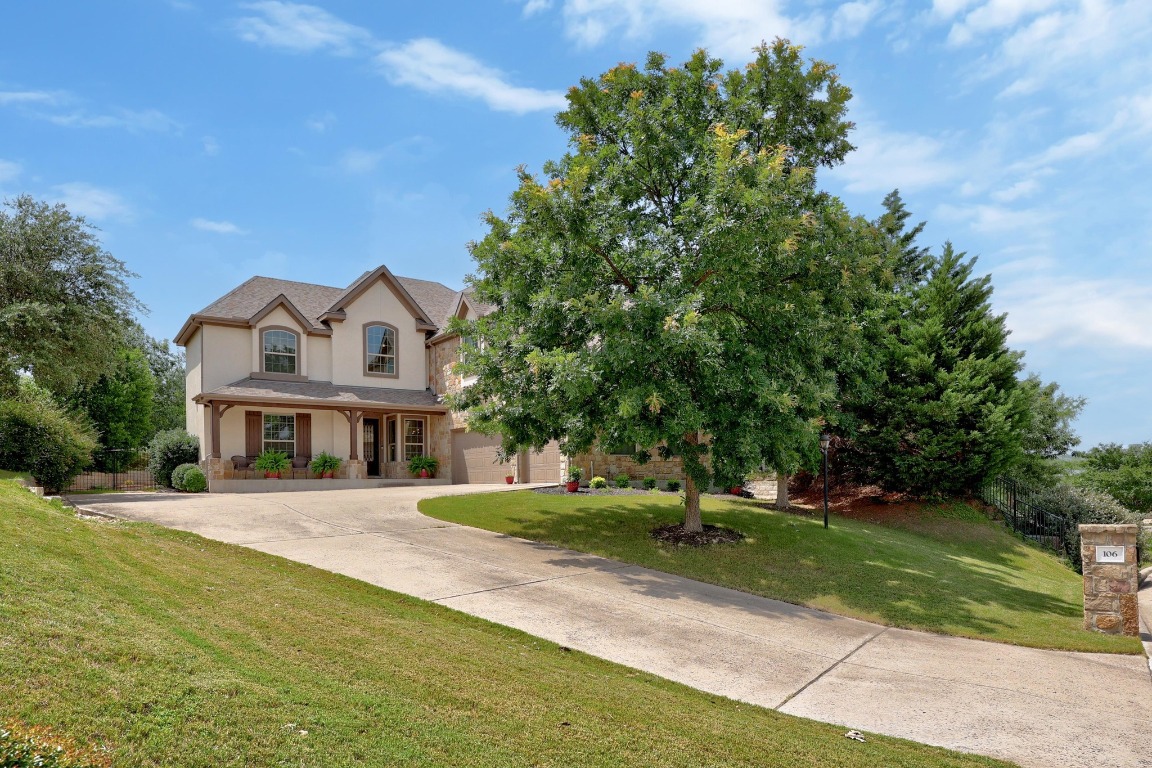 106 Tonkawa Trail West Austin, TX 78738 - Photo 6 of 39 a front view of a house with a yard