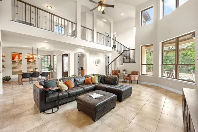 a living room with furniture ceiling fan and a rug