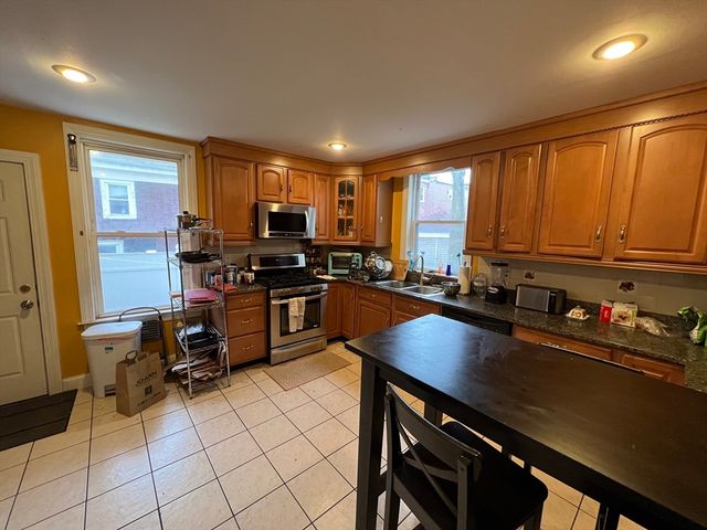a kitchen with a sink cabinets and appliances