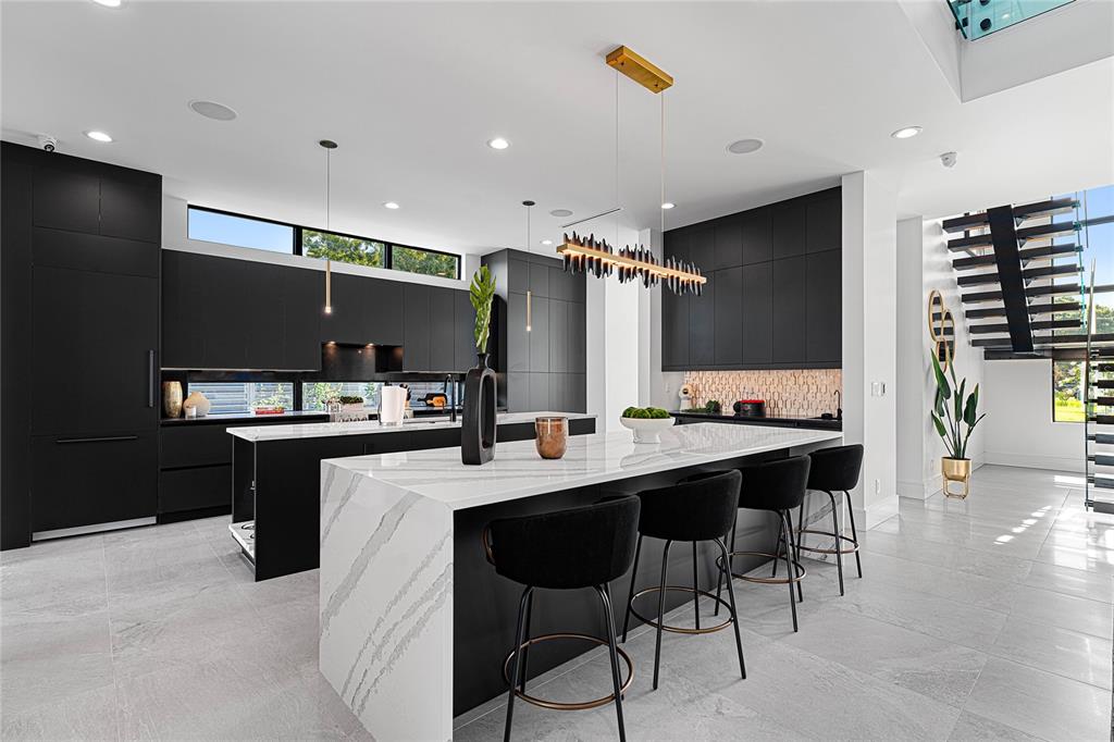 2519 North Riverside Drive Tampa, FL 33602 - Photo 13 of 34 a kitchen with kitchen island stainless steel appliances a sink and cabinets