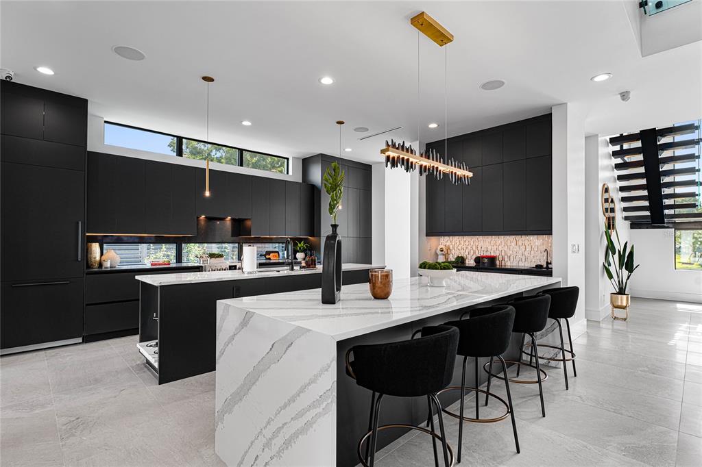 2519 North Riverside Drive Tampa, FL 33602 - Photo 20 of 34 a large kitchen with a counter space a sink stainless steel appliances and cabinets