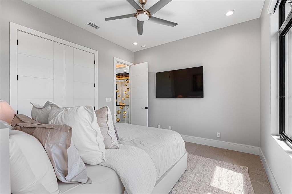 2519 North Riverside Drive Tampa, FL 33602 - Photo 26 of 34 a bedroom with a bed and a flat screen tv