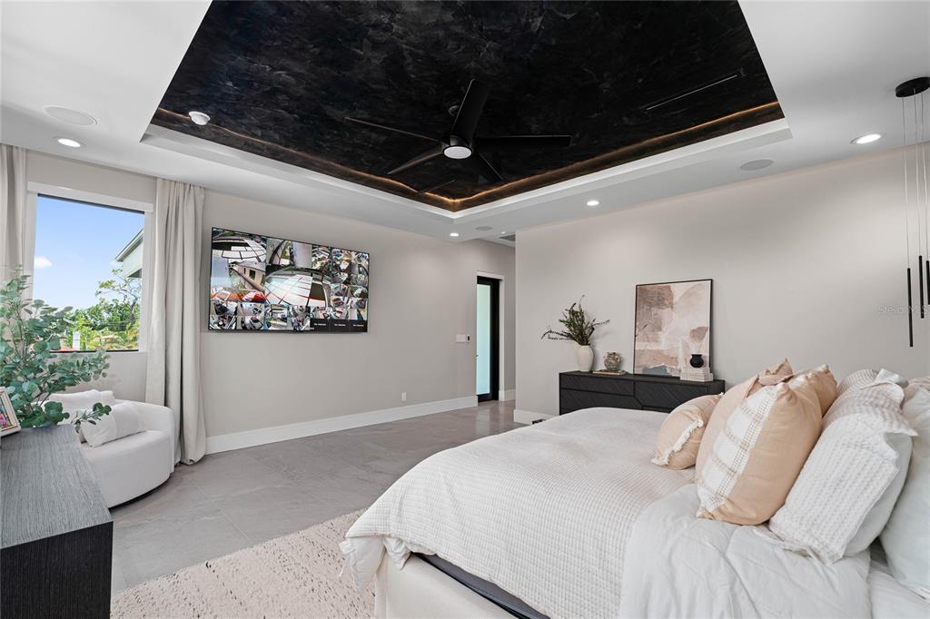 2519 North Riverside Drive Tampa, FL 33602 - Photo 29 of 34 a bedroom with a large bed and a chandelier