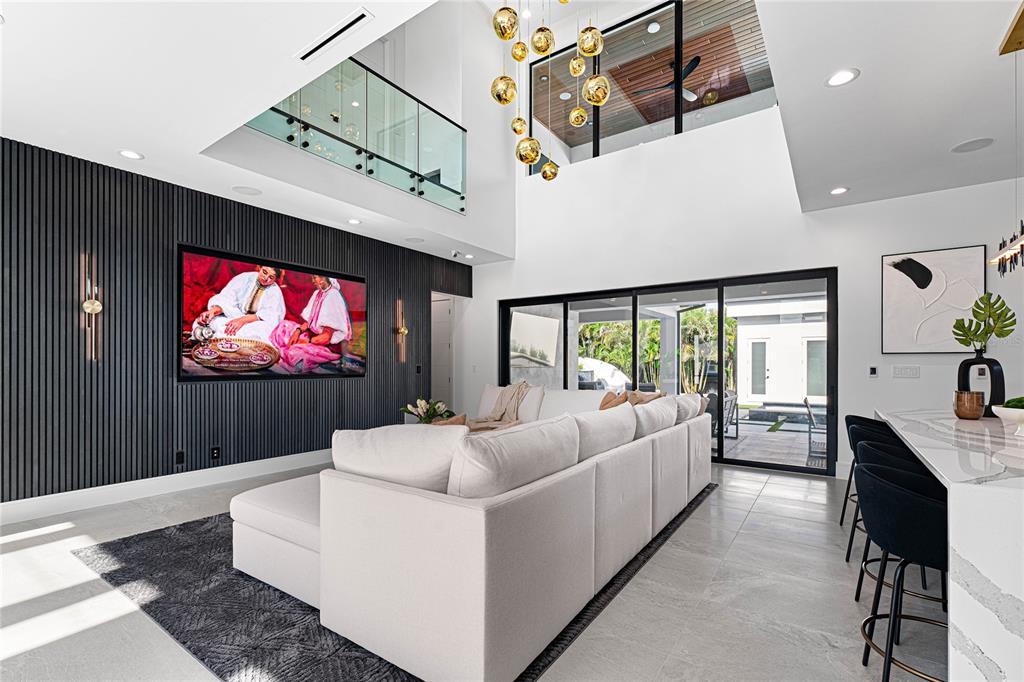 2519 North Riverside Drive Tampa, FL 33602 - Photo 7 of 34 a living room with furniture a flat screen tv and a floor to ceiling window