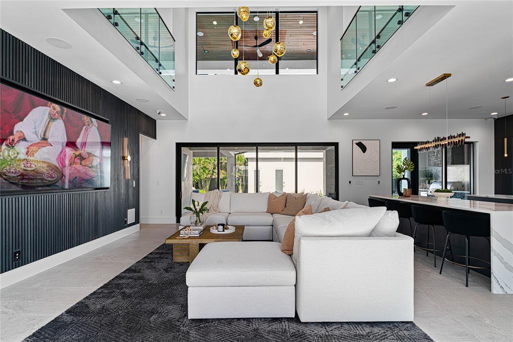 2519 North Riverside Drive Tampa, FL 33602 - Photo 8 of 34 a living room with furniture a fireplace and potted plants with wooden floor