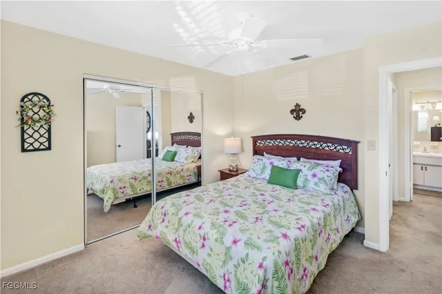 a bedroom with two beds and painting on the wall