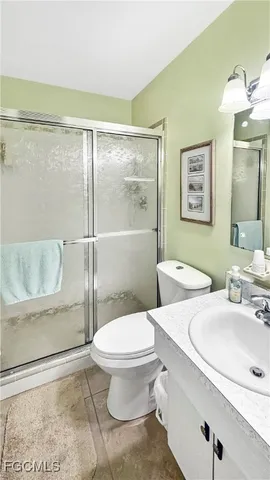 a bathroom with a toilet a sink and shower