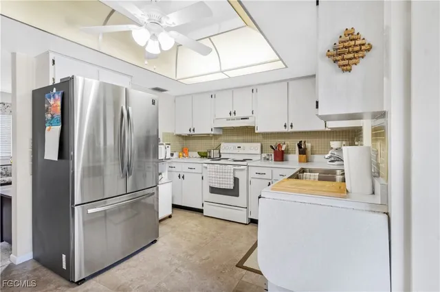 a kitchen with stainless steel appliances a refrigerator sink and stove