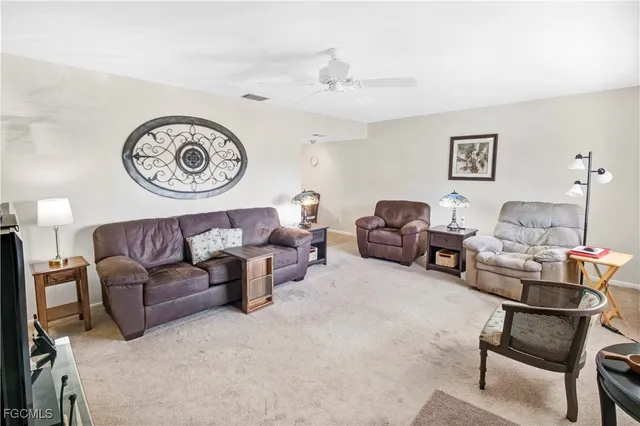 a living room with furniture and a clock