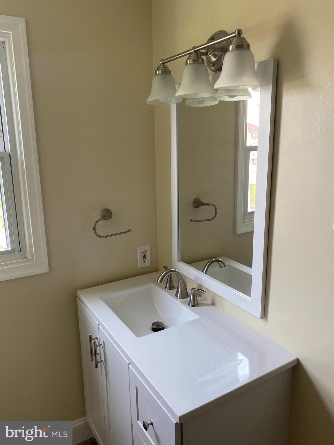 136-138 Reeger Avenue Hamilton, NJ 08610 - Photo 13 of 18 a bathroom with a sink and a mirror