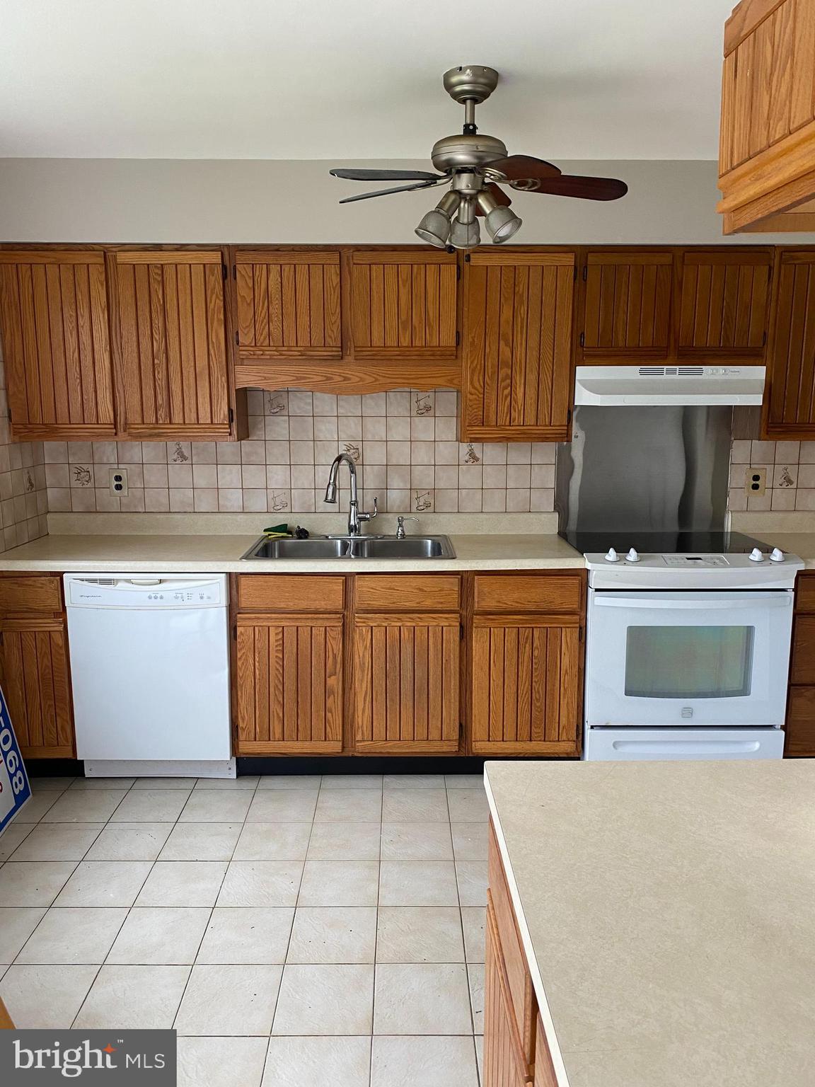 136-138 Reeger Avenue Hamilton, NJ 08610 - Photo 3 of 18 a kitchen with a sink a stove cabinets and a window
