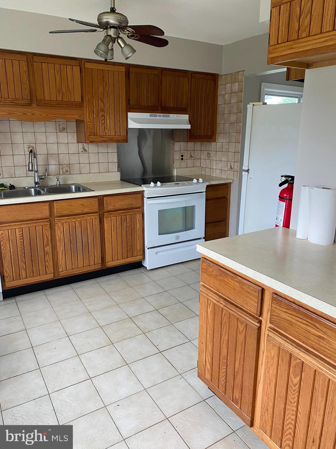 136-138 Reeger Avenue Hamilton, NJ 08610 - Photo 4 of 18 a kitchen with stainless steel appliances a stove a sink and white cabinets