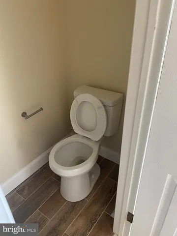 a white toilet sitting next to a small sink