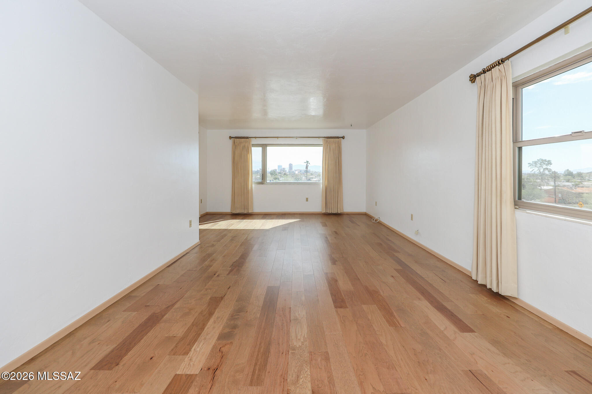 37 North Silverbell Road Tucson, AZ 85745 - Photo 13 of 31 an empty room with wooden floor and windows
