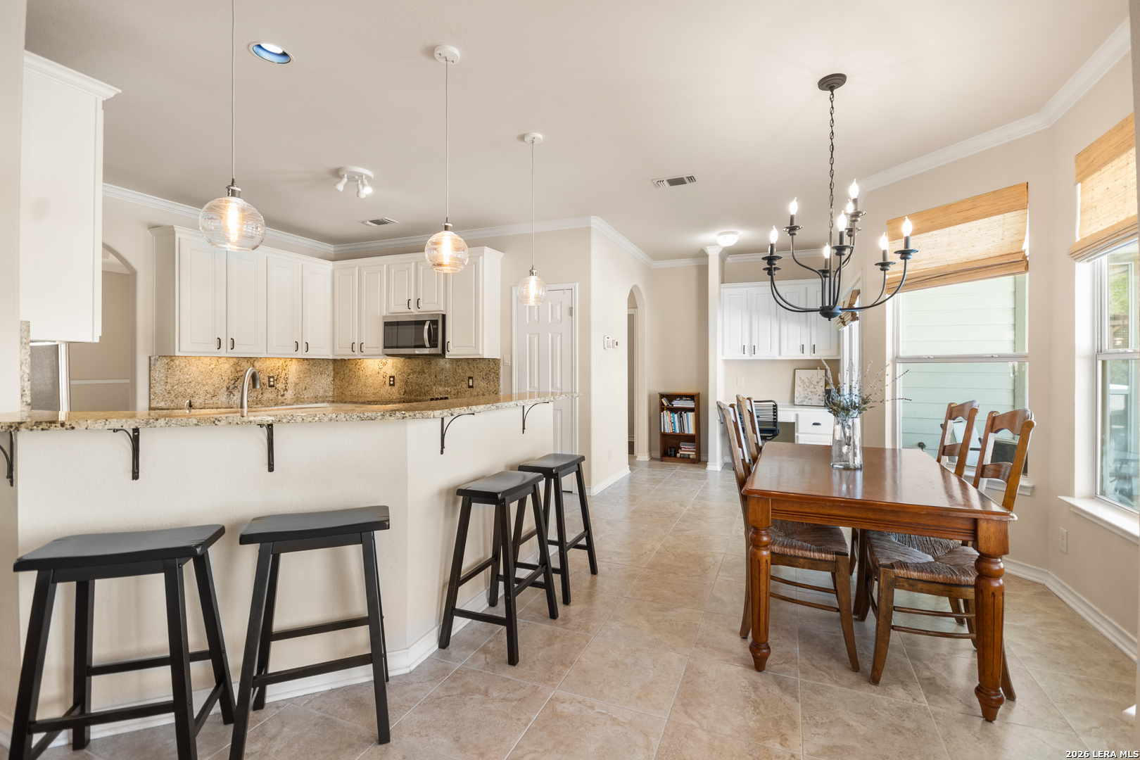 108 Jackrabbit Circle Boerne, TX 78006 - Photo 23 of 50 a kitchen with kitchen island a dining table chairs and white cabinets