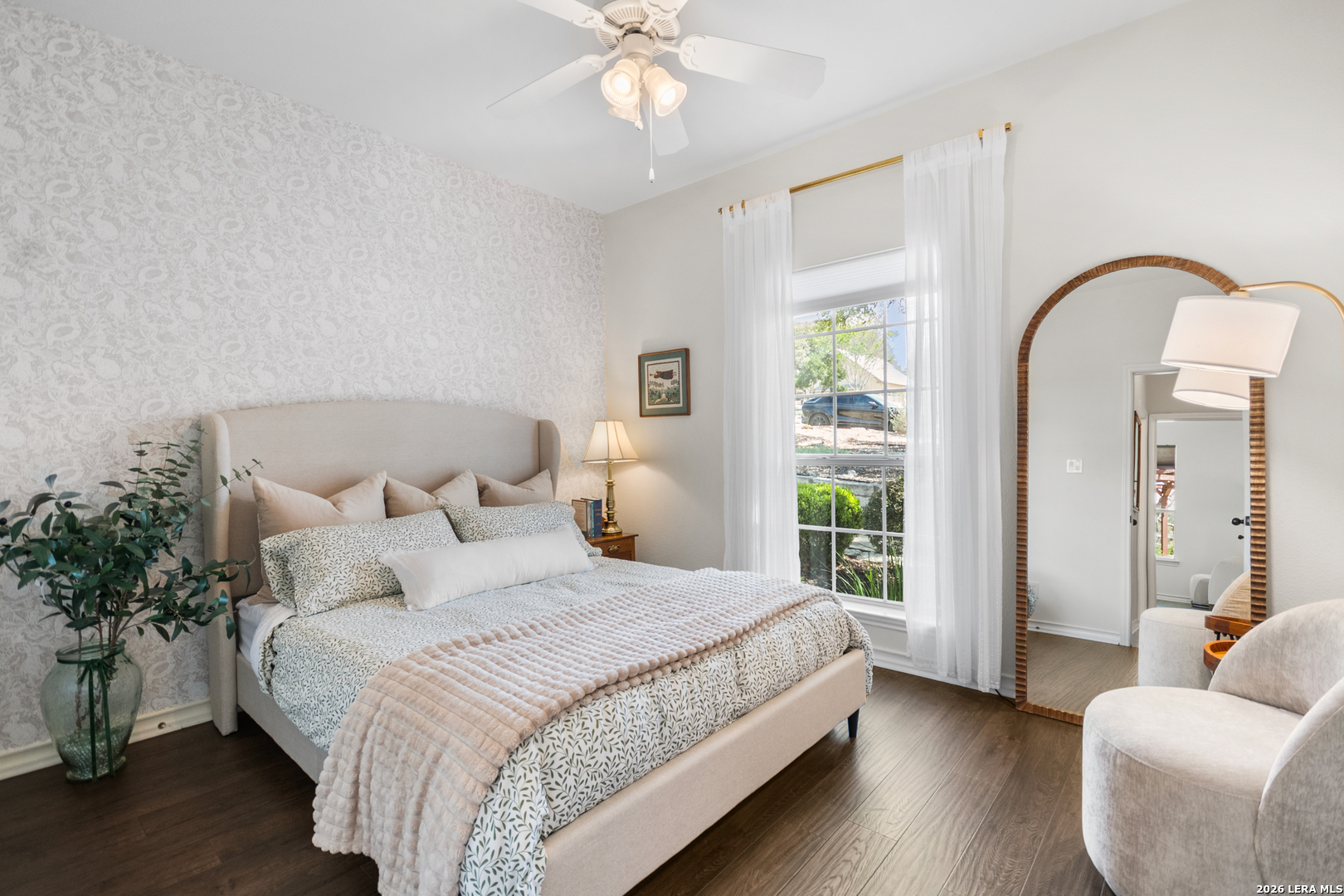 108 Jackrabbit Circle Boerne, TX 78006 - Photo 35 of 50 a spacious bedroom with a bed and a chandelier