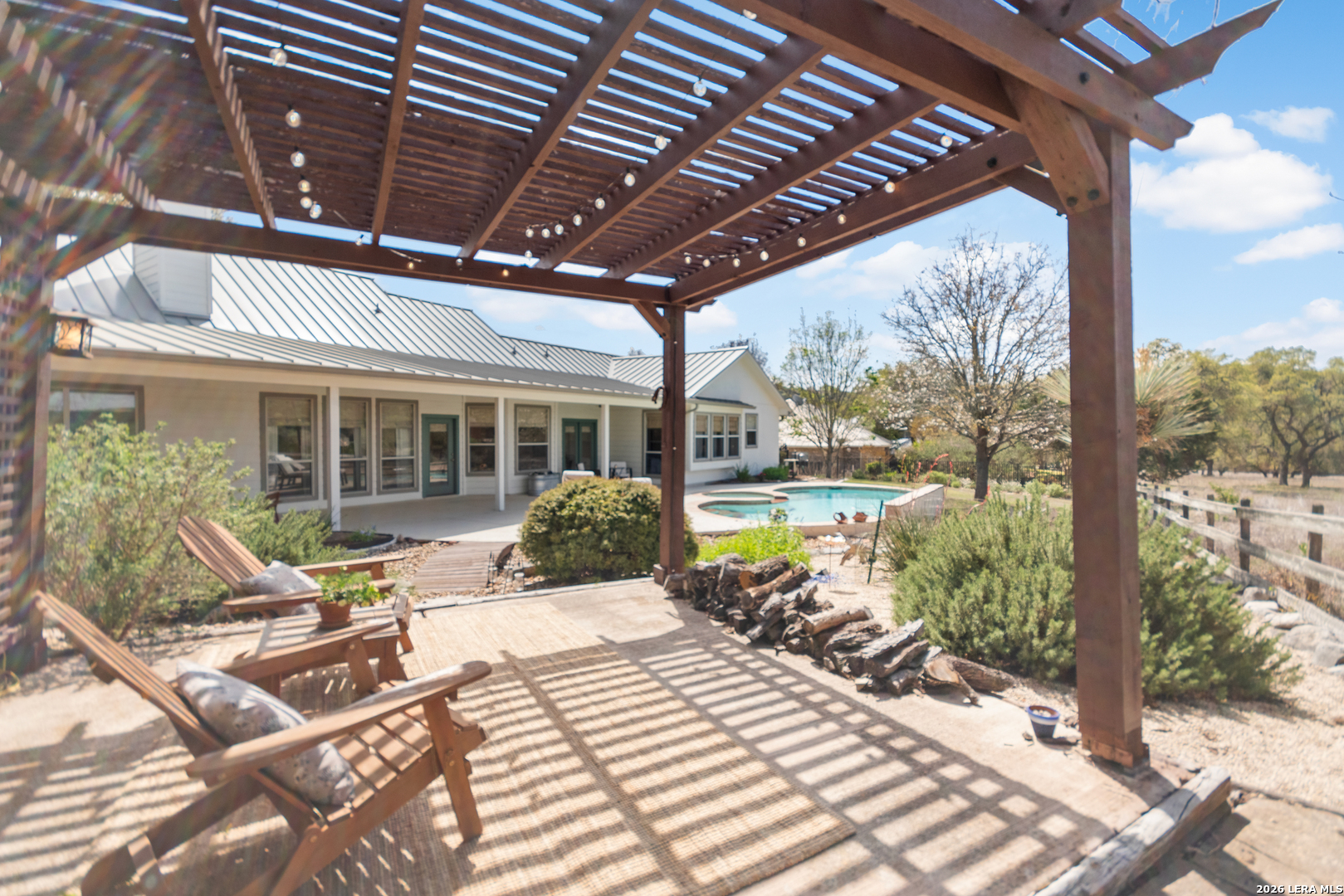 108 Jackrabbit Circle Boerne, TX 78006 - Photo 45 of 50 a view of a patio with table and chairs floor to ceiling window with wooden floor