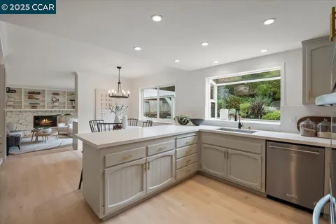 a kitchen with sink stove and cabinets