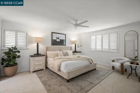 a bedroom with a bed and a potted plant