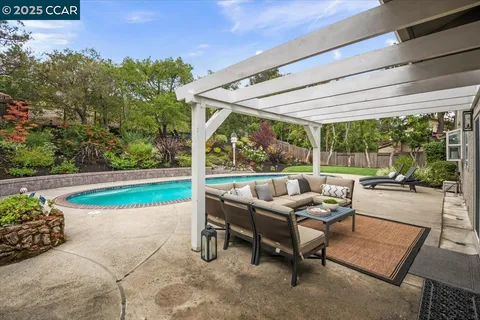 a building outdoor space with patio furniture and garden