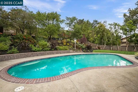 a view of a swimming pool with an outdoor space and seating area