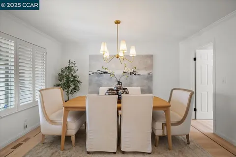 a view of a dining room with furniture and chandelier