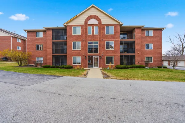 a view of a brick building next to a yard