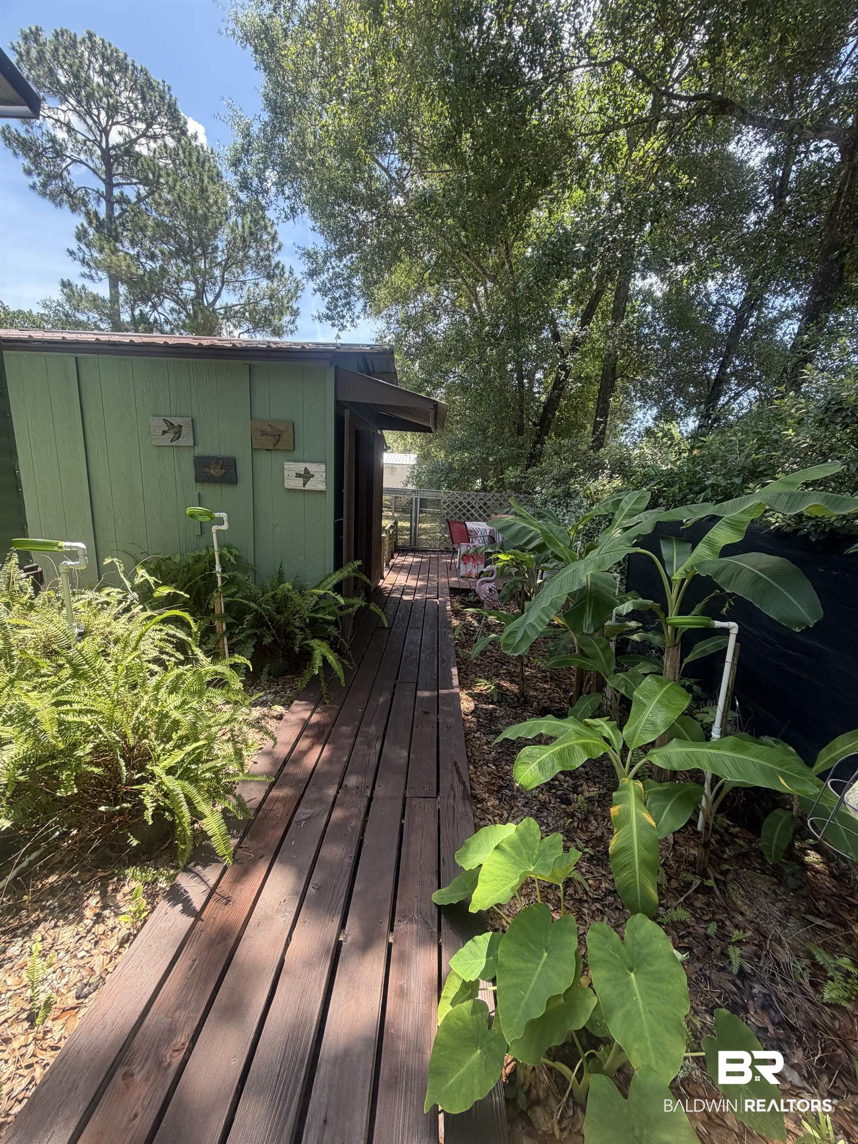 1620 Del Rey Drive Lillian, AL 36549 - Photo 25 of 45 Outdoor wooden walkway leading to a private patio area