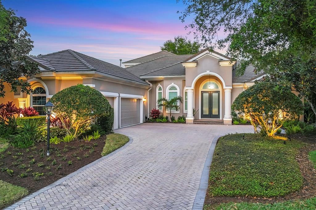 7257 Greystone Street Lakewood Ranch, FL 34202 - Photo 1 of 1 a front view of a house with garden