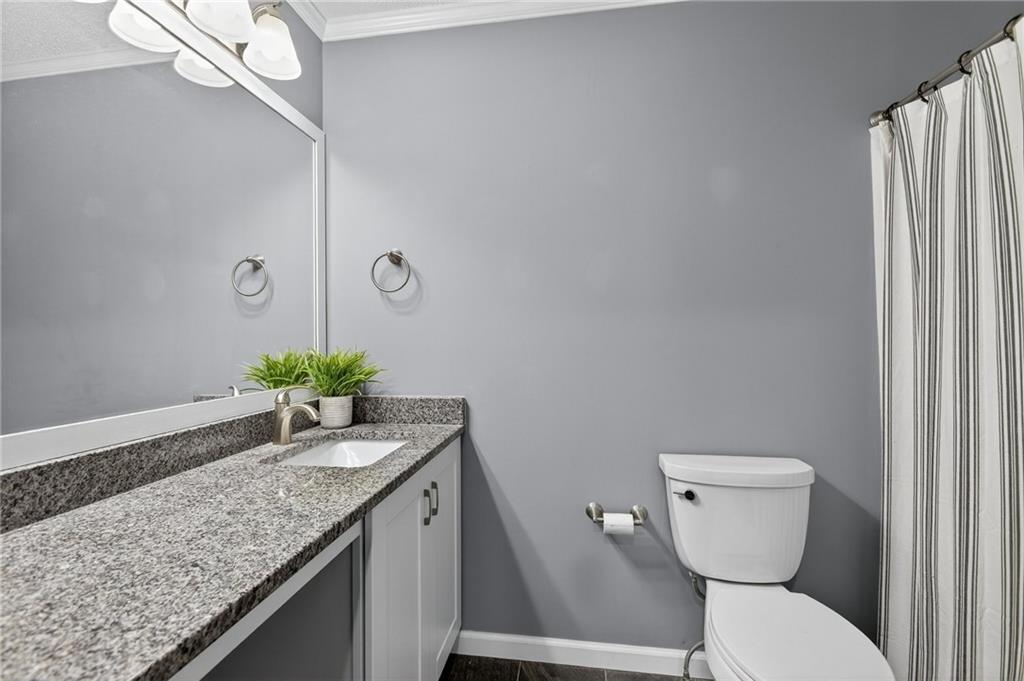 15 Bluegrass Cove Northeast Cartersville, GA 30121 - Photo 38 of 51 a bathroom with a granite countertop sink a toilet and mirror
