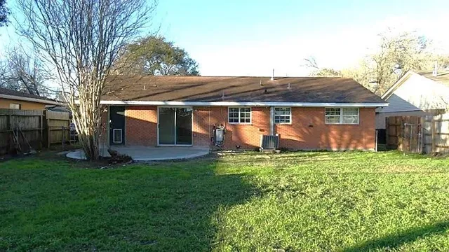 a front view of house with a garden