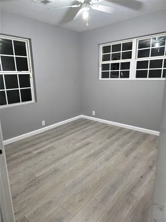 an empty room with wooden floor and closet