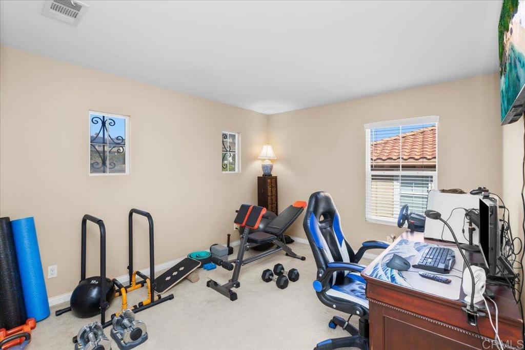 838 Luminara Way San Marcos, CA 92078 - Photo 41 of 54 a view of a workspace with gym equipment