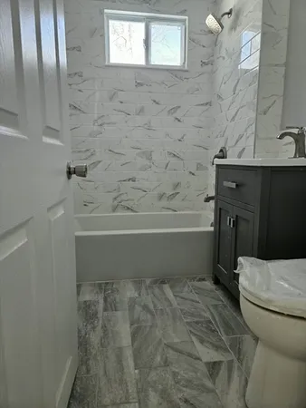 a bathroom with a sink a toilet and bathtub