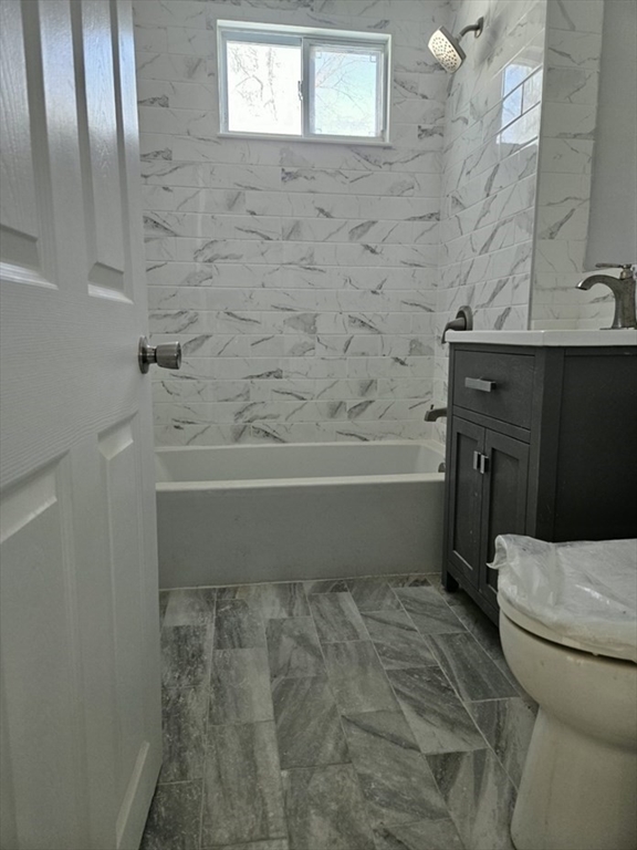 9 Victoria Street, Unit 1 Lowell, MA 01851 - Photo 4 of 8 a bathroom with a toilet and a shower