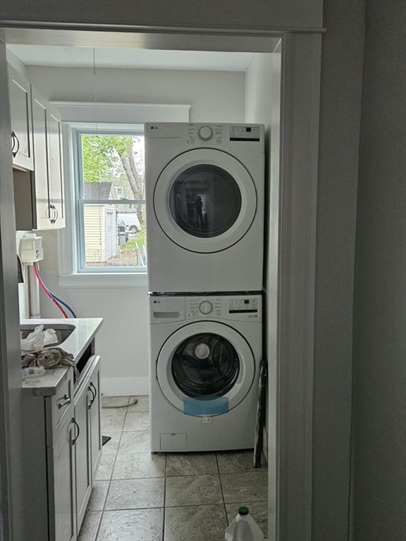 9 Victoria Street, Unit 1 Lowell, MA 01851 - Photo 8 of 8 a utility room with sink washer and dryer
