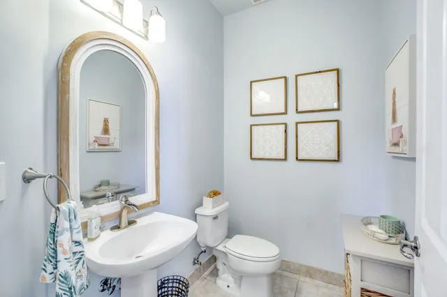 a front view of a house with a yard and potted plants