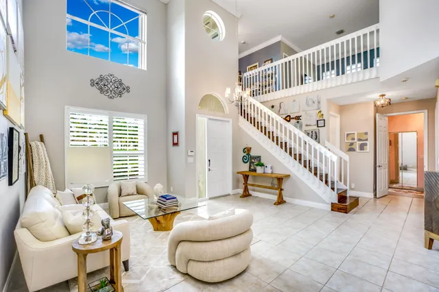 a living room with furniture a window and a chandelier