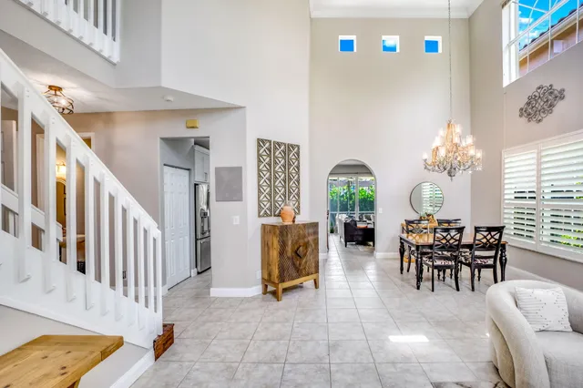 a kitchen with stainless steel appliances kitchen island granite countertop a stove a sink a chairs and a dining table