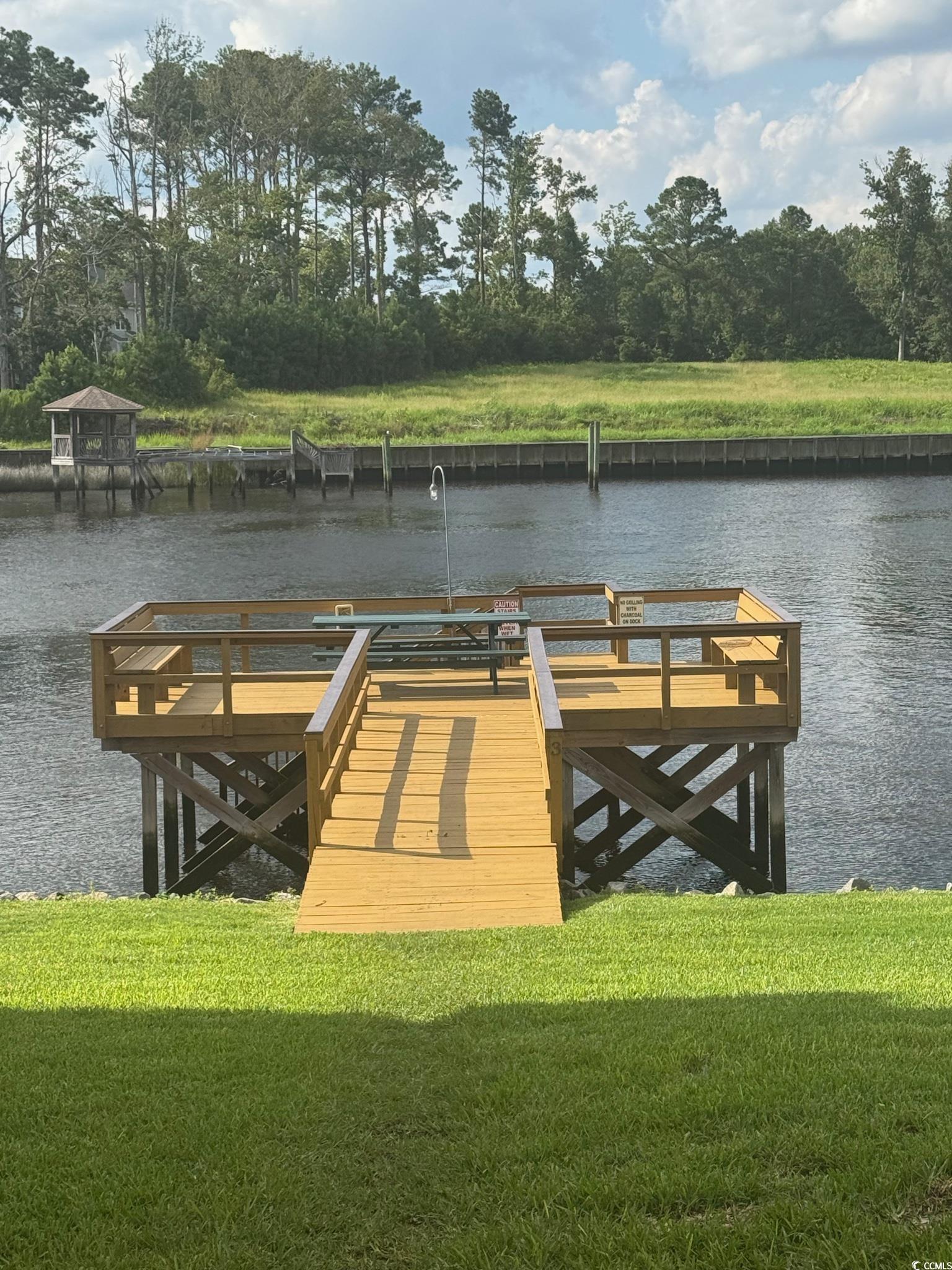 209 Landing Road, Unit H North Myrtle Beach, SC 29582 - Photo 27 of 30 Dock featuring a water view and a yard