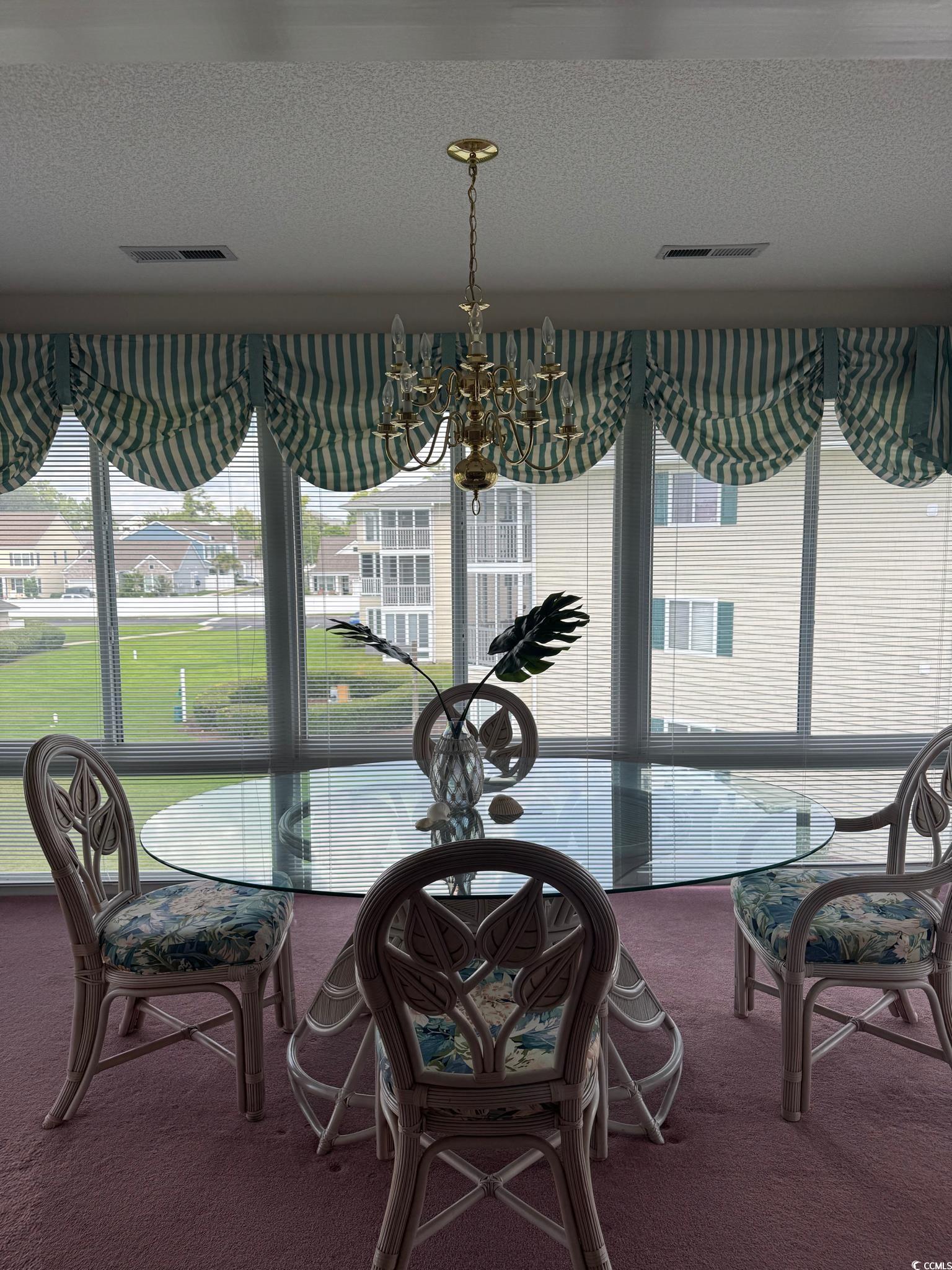 209 Landing Road, Unit H North Myrtle Beach, SC 29582 - Photo 7 of 30 Dining room featuring a textured ceiling, plenty of natural light, and dark carpet