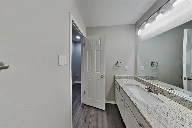 an empty room and chandelier fan