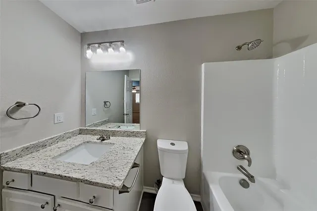 a kitchen with a stove and wooden floor