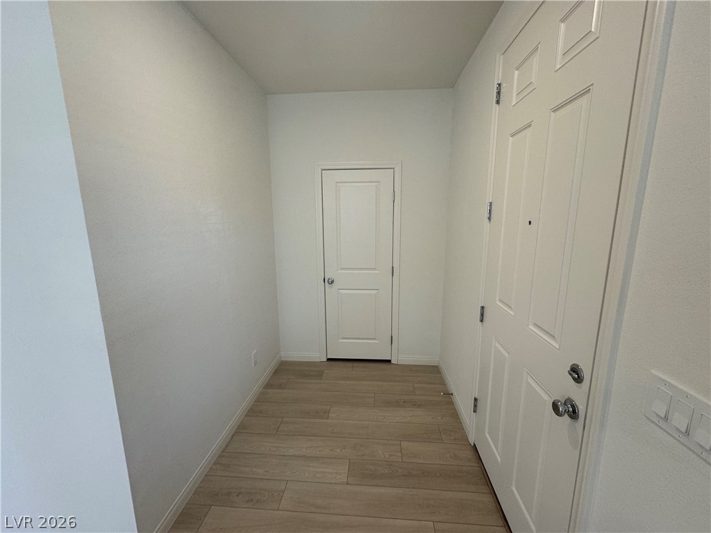 2821 Alcobaca Street Henderson, NV 89044 - Photo 7 of 24 A welcoming entry featuring warm wood flooring and clean, freshly painted walls.