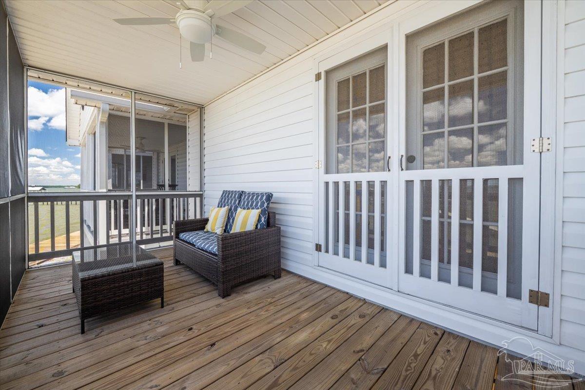 26063 Canal Road, Unit 3F Orange Beach, AL 36561 - Photo 50 of 72 a balcony with wooden floor and furniture