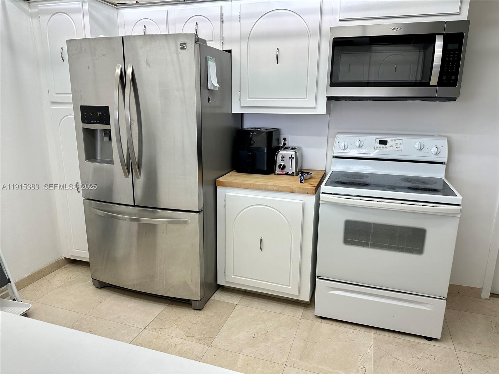 199 Ocean Ln Drive, Unit 1004 Key Biscayne, FL 33149 - Photo 11 of 12 a kitchen with stainless steel appliances a refrigerator stove and microwave