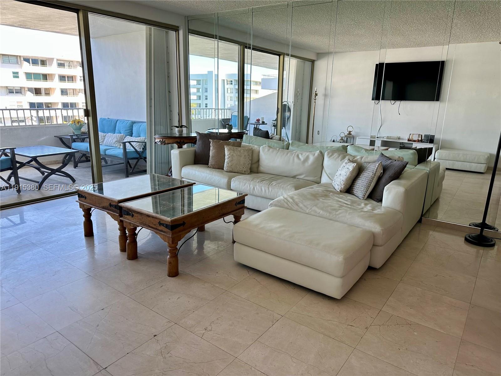 199 Ocean Ln Drive, Unit 1004 Key Biscayne, FL 33149 - Photo 3 of 12 a living room with furniture and a flat screen tv