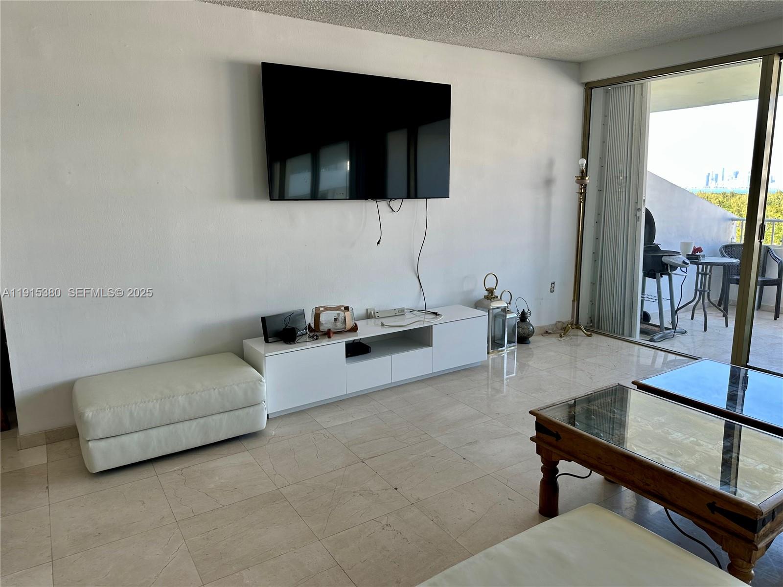 199 Ocean Ln Drive, Unit 1004 Key Biscayne, FL 33149 - Photo 4 of 12 a living room with furniture and a flat screen tv
