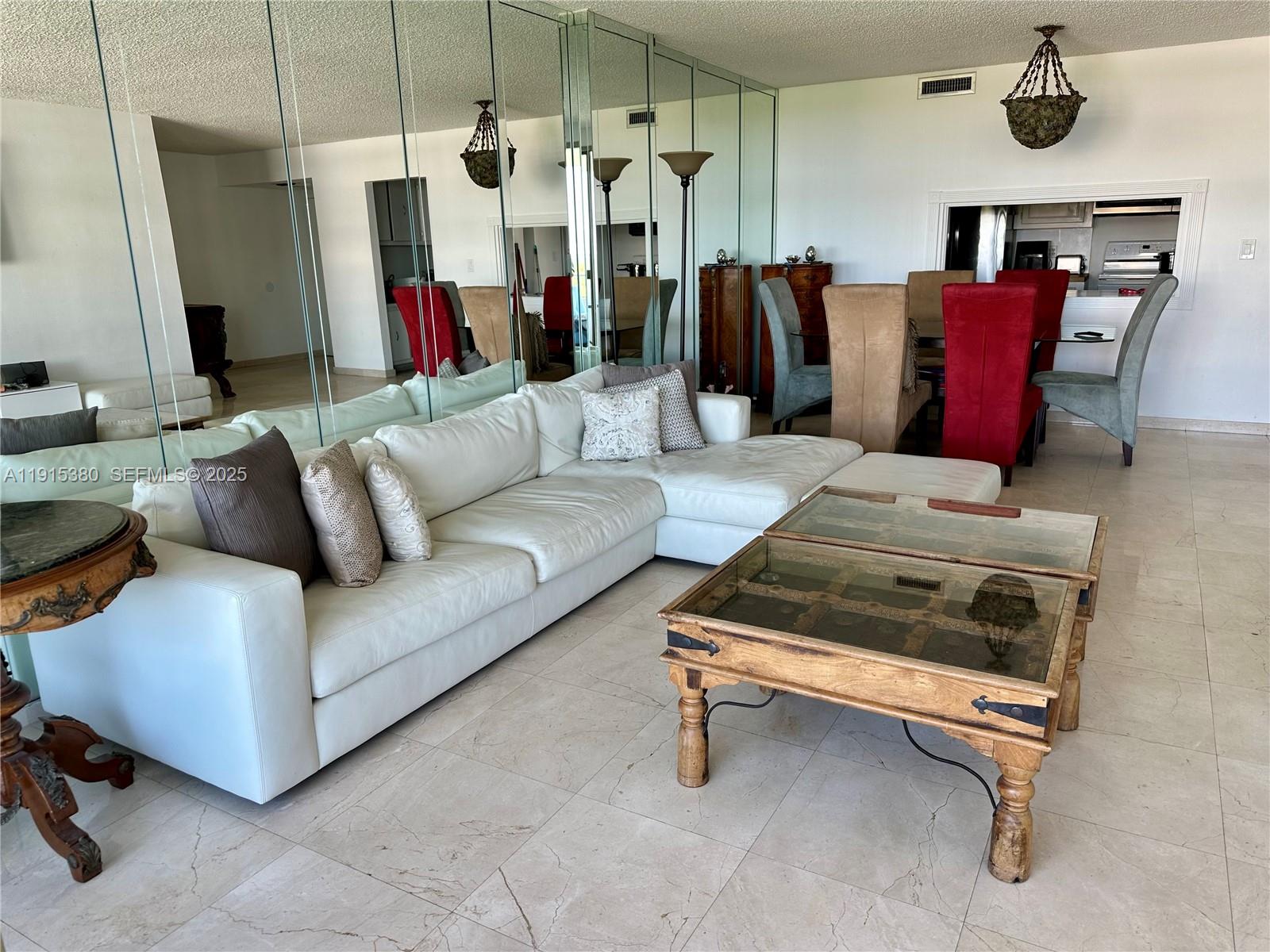 199 Ocean Ln Drive, Unit 1004 Key Biscayne, FL 33149 - Photo 5 of 12 a living room with furniture and a chandelier