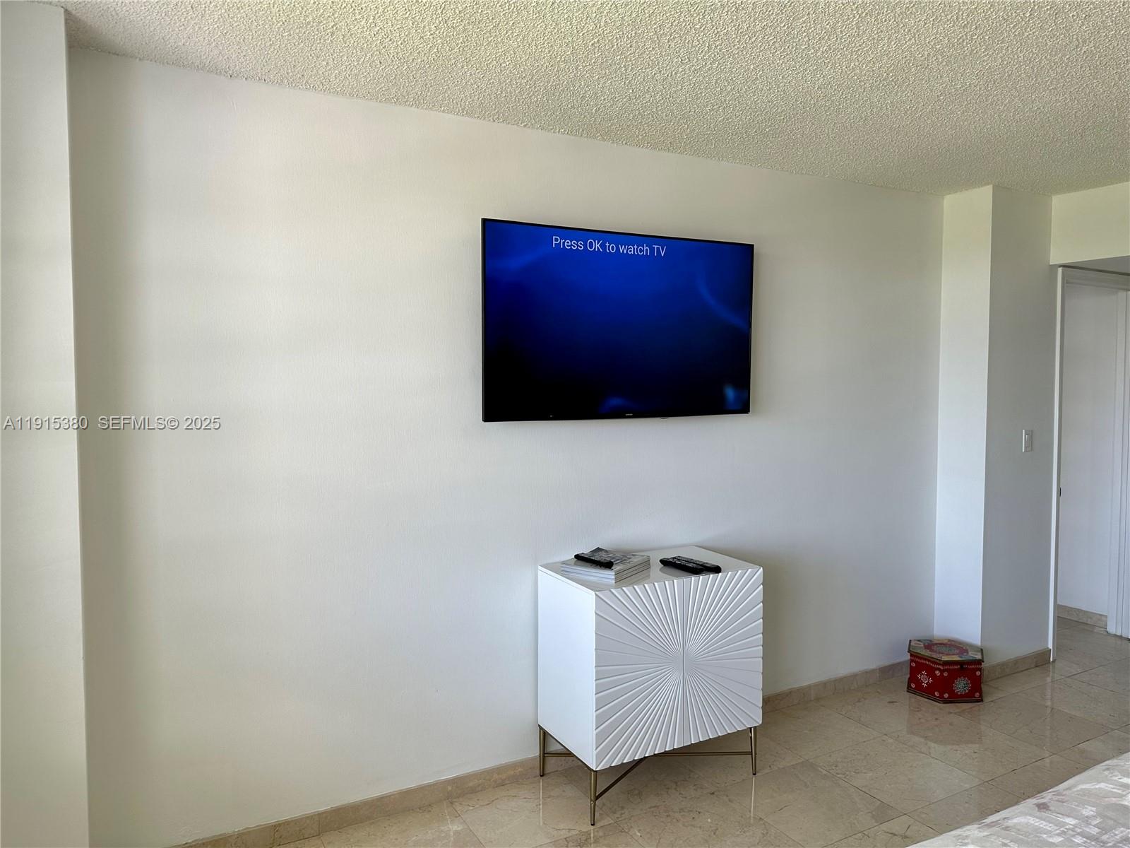 199 Ocean Ln Drive, Unit 1004 Key Biscayne, FL 33149 - Photo 7 of 12 a living room with furniture and a flat screen tv